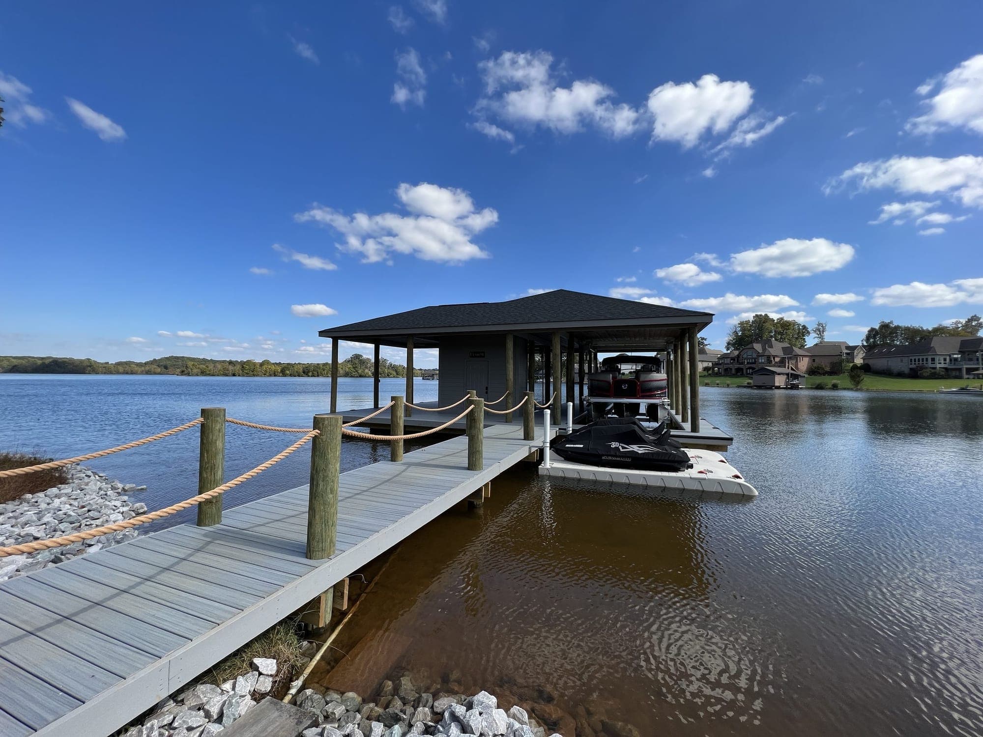Covered DOCK&DECK boat dock with a long walkway on Tellico Lake