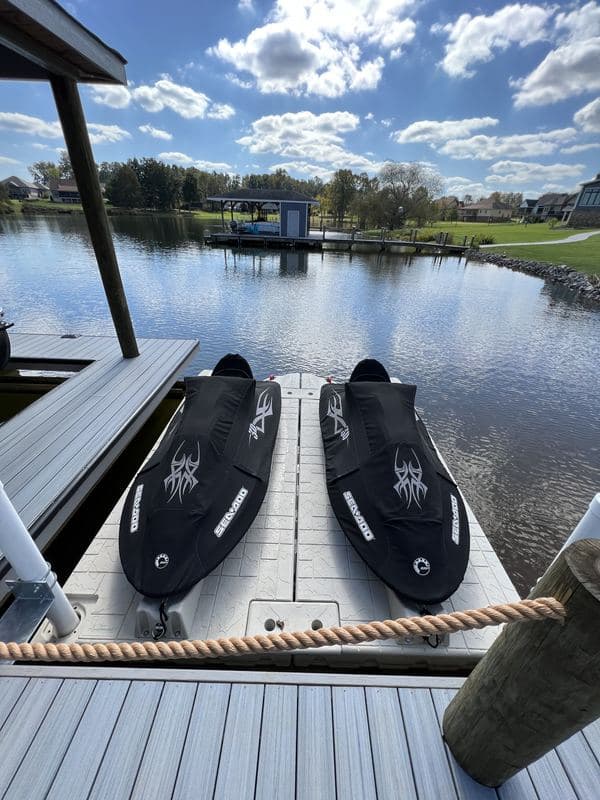 Two jet skis on floating drive-on ports beside the dock