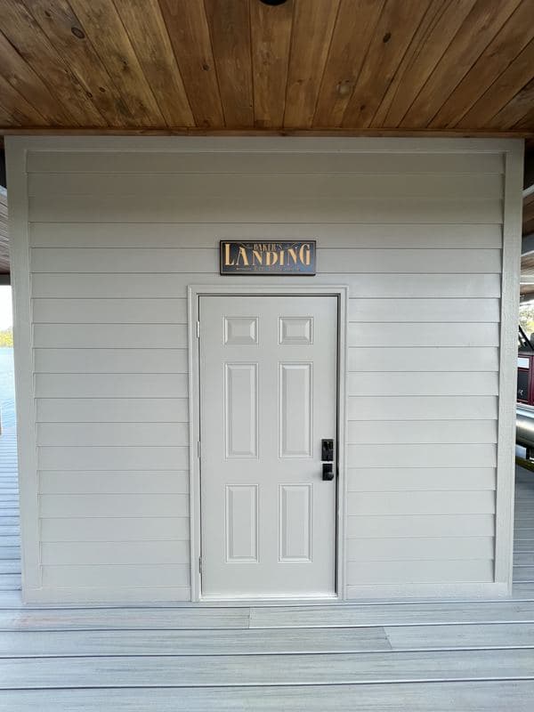 Enclosed dock storage room with a white door under the covered roof