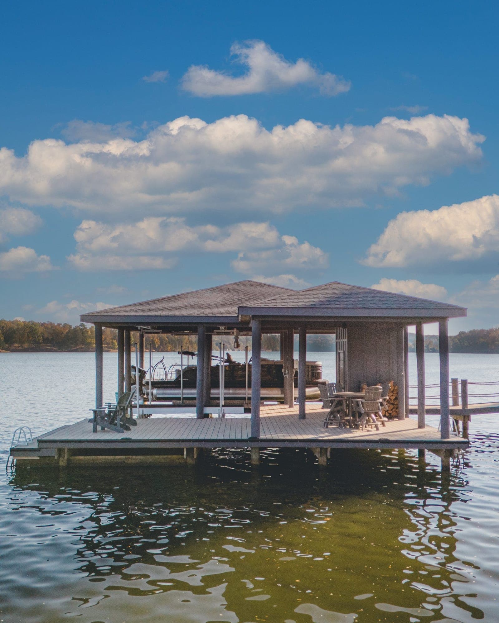 Covered boat dock with a hip roof and lounge deck on Fort Loudoun Lake in Lenoir City, TN