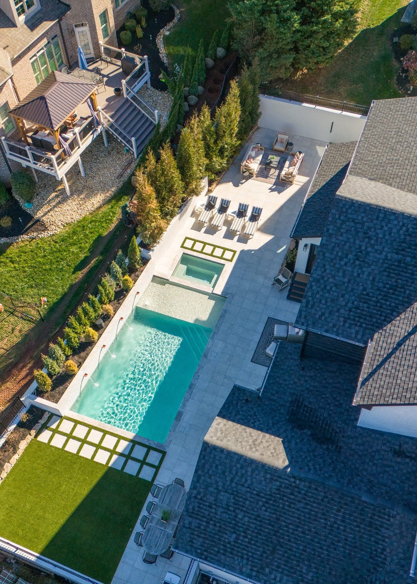 Aerial view of a long rectangular pool, spa and patio in a West Knoxville, TN backyard