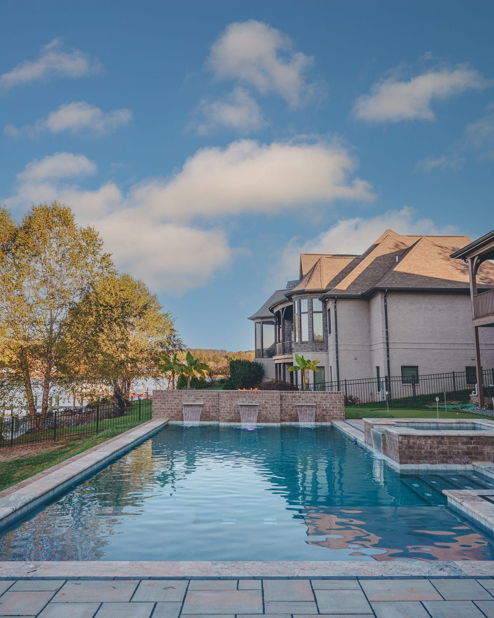 Rectangular pool with a raised spa behind a home in Knoxville, TN