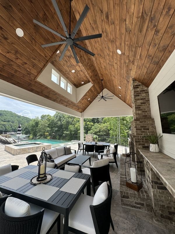 Pavilion dining area with wood ceiling looking out toward the pool