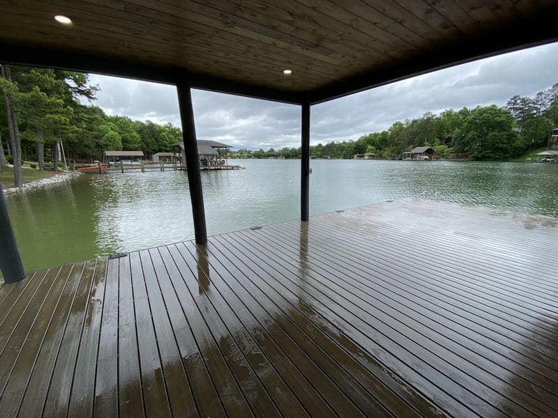 Wide interior view of the covered dock with boat slip and lake beyond