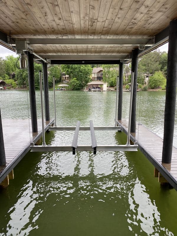 Empty boat slip with a lift under a wood plank ceiling