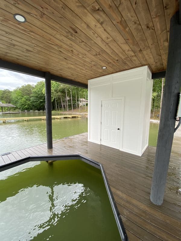 Angled boat slip beside the enclosed storage room inside the covered dock