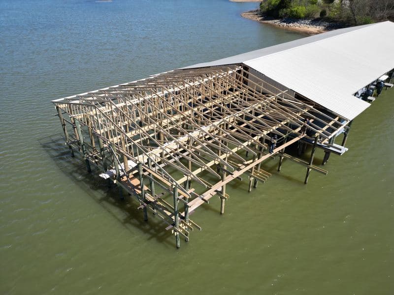 Aerial view of new timber truss framing extending the covered marina over the water