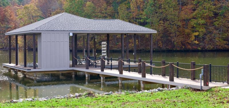 Covered dock and railed walkway from the shoreline lawn