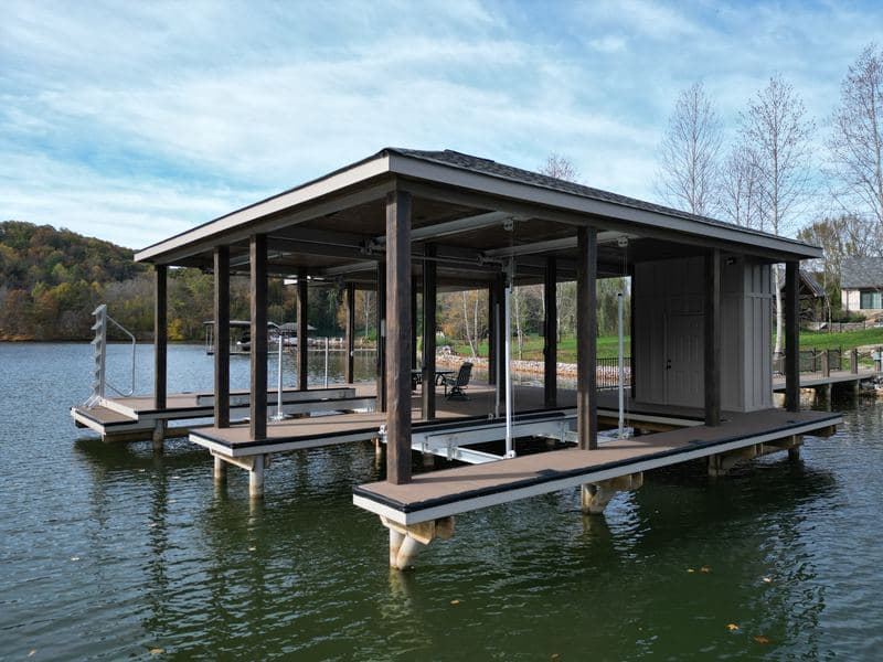 Side view of the covered dock with slips, lifts, and swim ladder