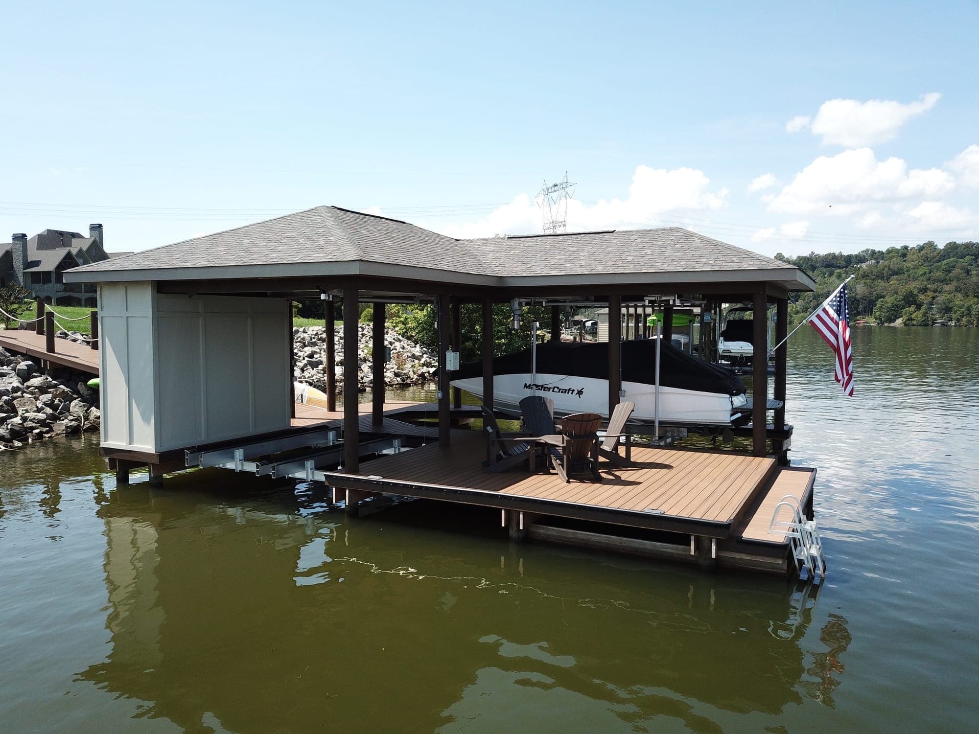 Covered boat dock with a hip roof and lounge deck on Fort Loudoun Lake in Louisville, TN