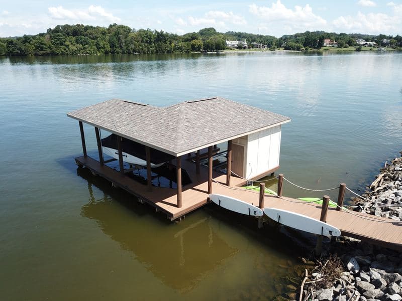 Covered dock with enclosed storage and walkway along the shoreline